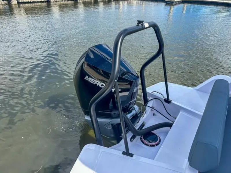 Slide: The Image of 2024 Axopar 25 Cross Top with Mercury outboard engine on water. - 20