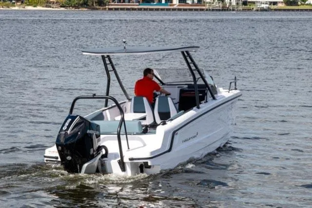 Slide: The Image of 2024 Axopar 25 Cross Top boat cruising on a calm lake. - 3