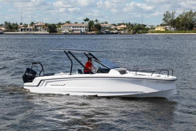 Slide: The Image of 2024 Axopar 25 Cross Top boat cruising on a sunny day. - 5