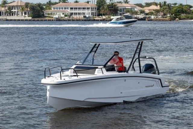 Slide: The Image of 2024 Axopar 25 Cross Top boat cruising on a sunny day. - 6