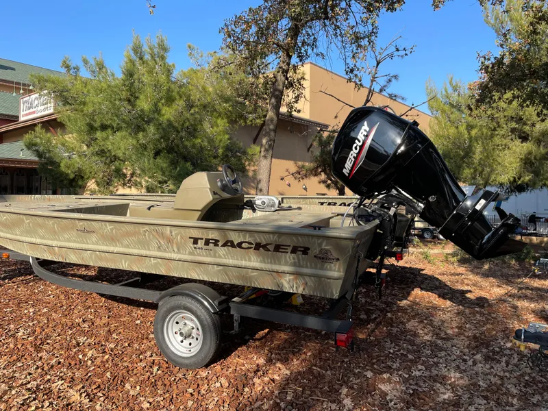Slide: The Image of 2024 Tracker Grizzly 1648 SC boat with Mercury outboard motor on trailer. - 2