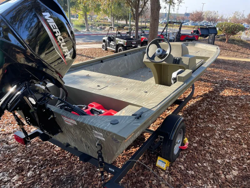 Slide: The Image of 2024 Tracker Grizzly 1648 SC boat with Mercury outboard motor on trailer. - 3
