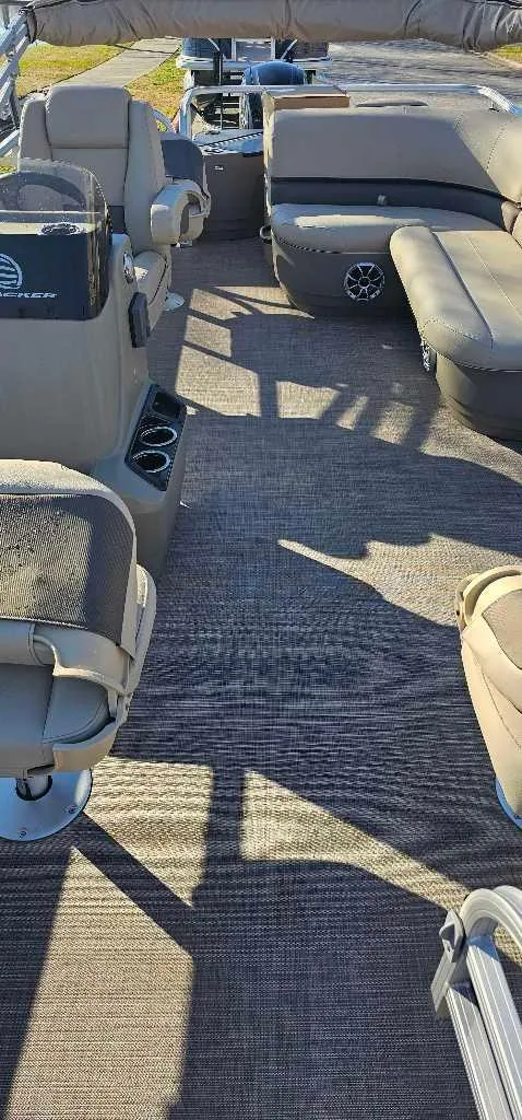 Slide: The Image of 2024 Sun Tracker Bass Buggy 18 DLX interior with seating and console. - 3