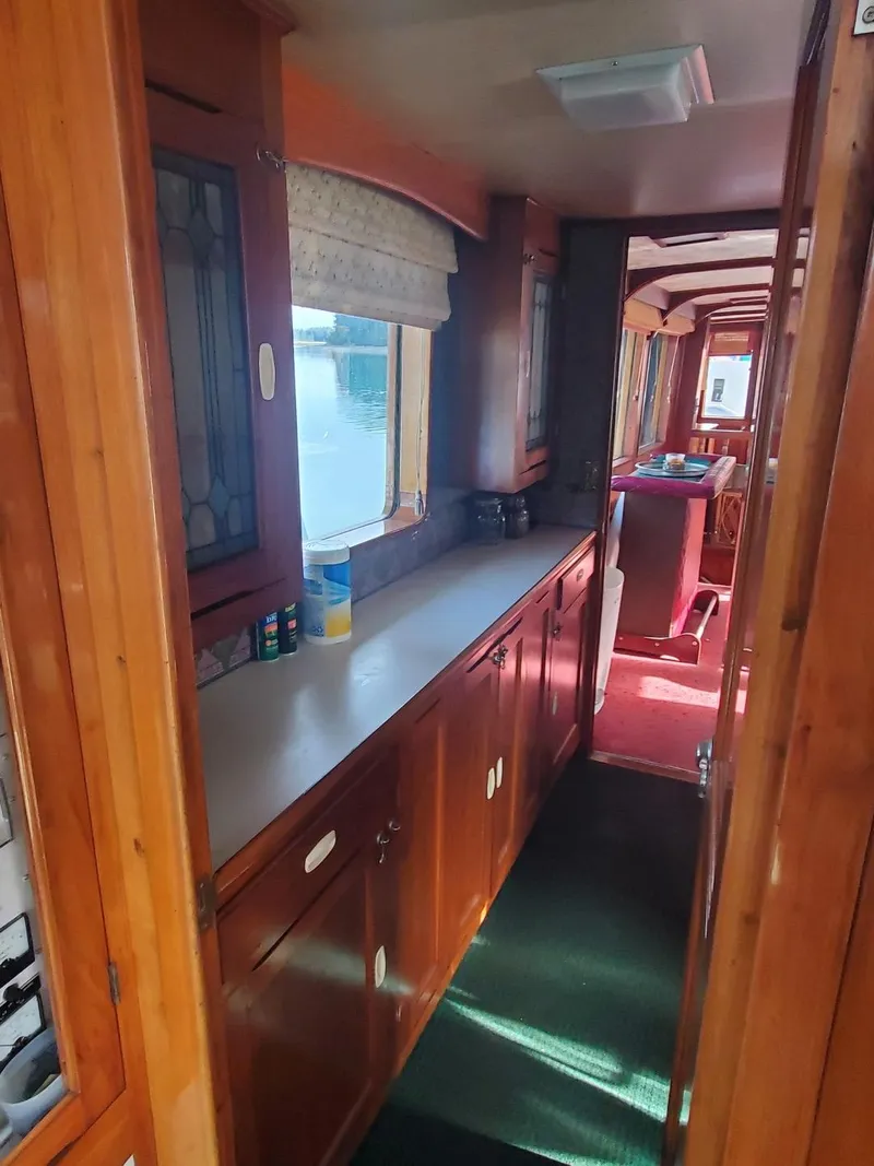 Slide: The Image of Interior hallway of 1974 Stephens 68 Motor Yacht with wooden cabinetry and countertops. - 11