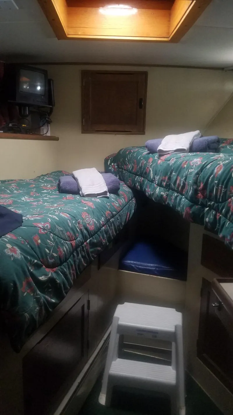 Slide: The Image of 1974 Stephens 68 Motor Yacht cabin with twin beds and floral bedding. - 16