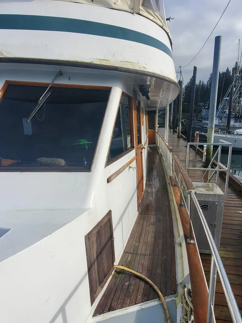 Slide: The Image of 1974 Stephens 68 Motor Yacht docked at a marina. - 3