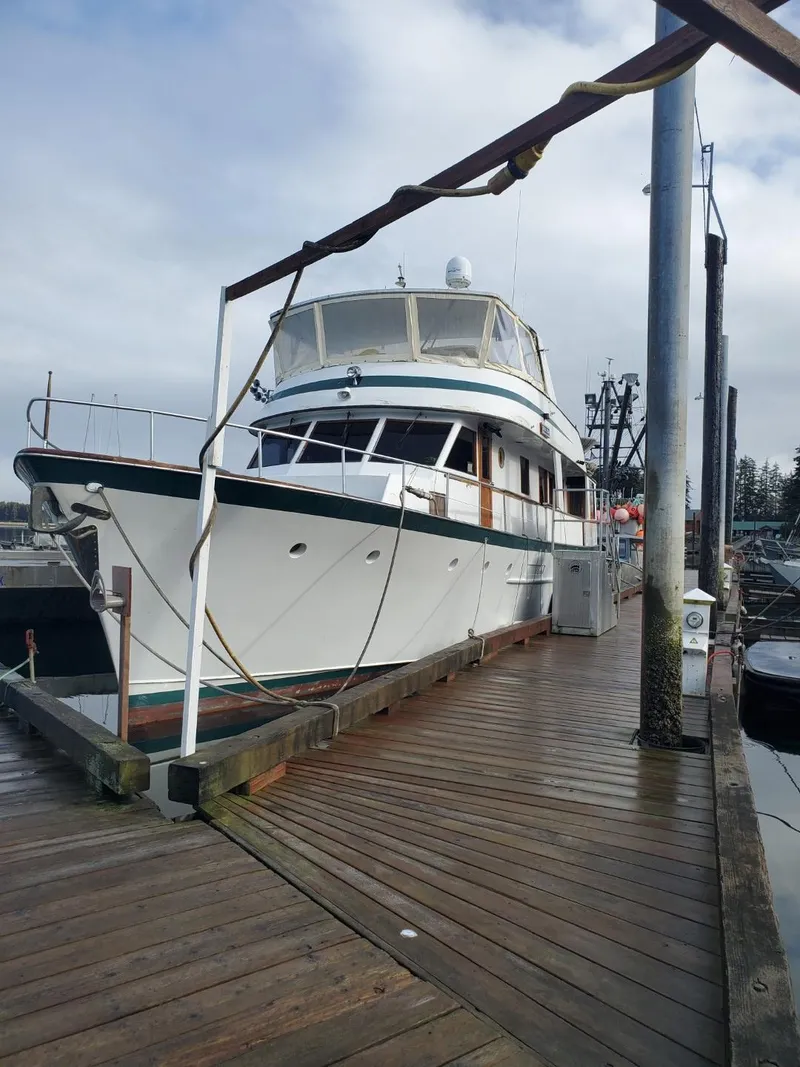 Slide: The Image of 1974 Stephens 68 Motor Yacht docked at a marina. - 5