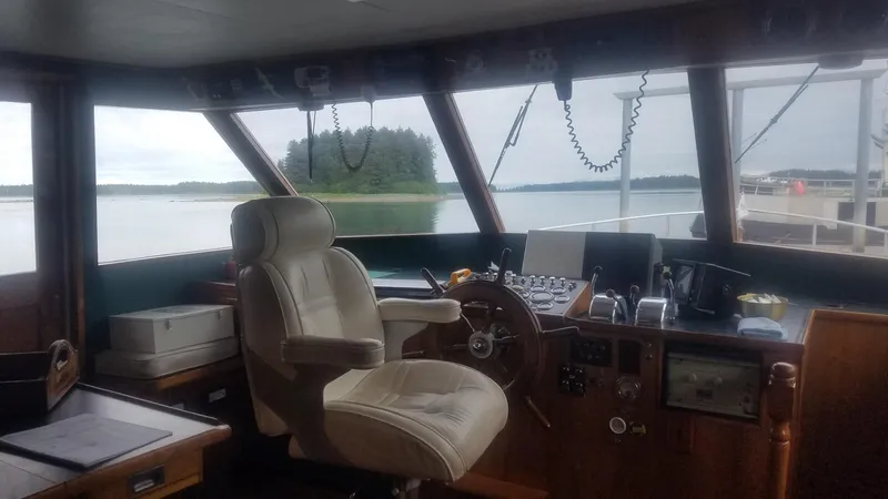 Slide: The Image of 1974 Stephens 68 Motor Yacht helm with panoramic water view. - 6