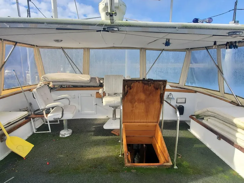 Slide: The Image of 1974 Stephens 68 Motor Yacht interior with open hatch and seating area. - 8