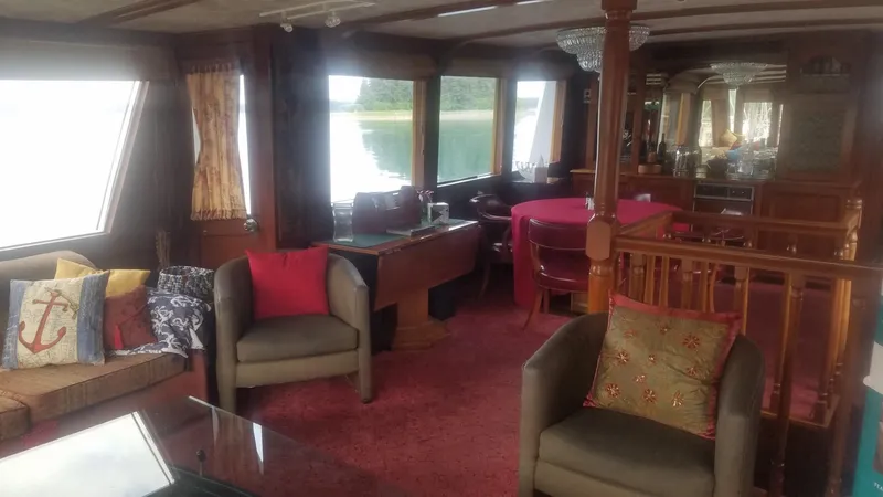 Slide: The Image of Interior of 1974 Stephens 68 Motor Yacht with cozy seating and large windows. - 9