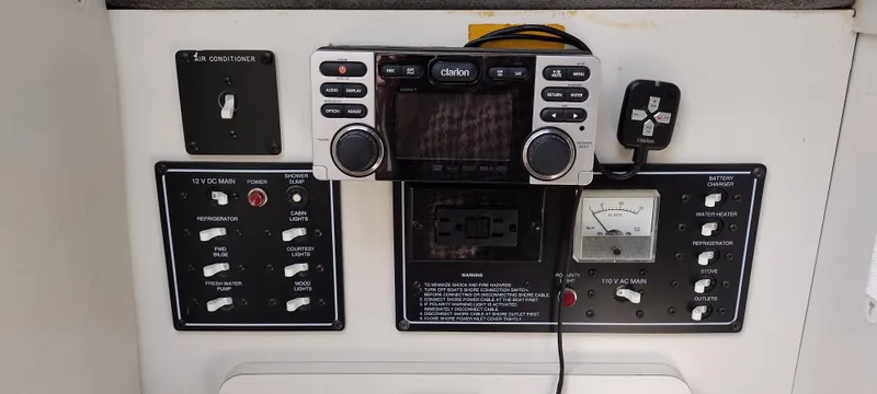 Slide: The Image of Control panel of a 1997 Crownline 250 CR boat with Clarion audio system. - 12