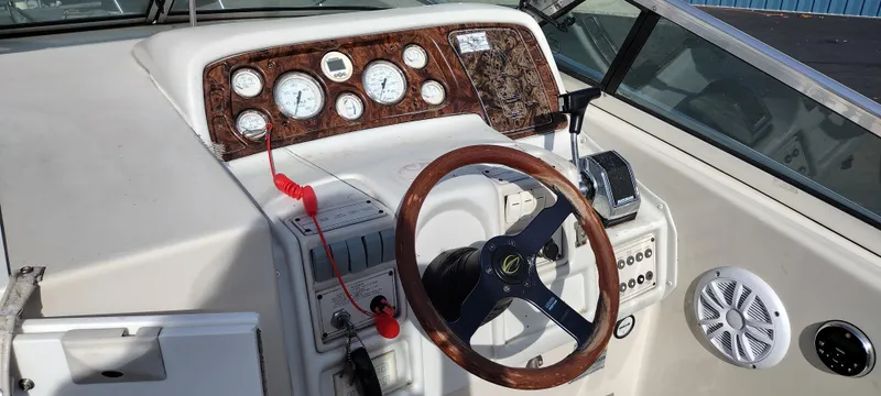 Slide: The Image of 1997 Crownline 250 CR boat dashboard with steering wheel and control panel. - 16