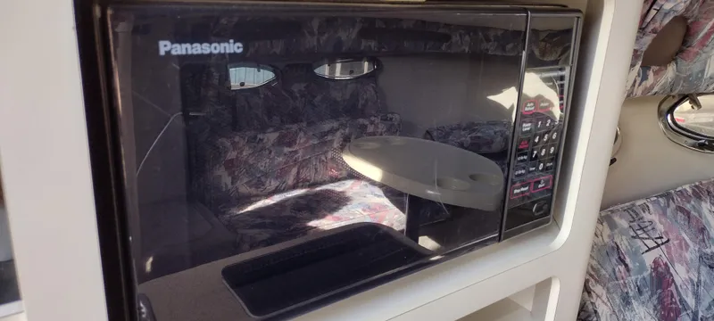 Slide: The Image of Built-in Panasonic microwave in 1997 Crownline 250 CR boat interior. - 20