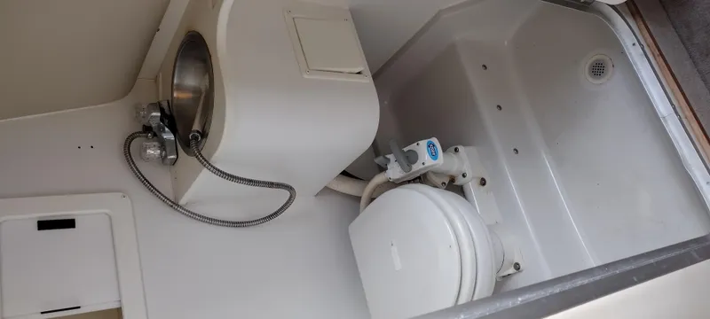 Slide: The Image of 1997 Crownline 250 CR boat bathroom with sink and toilet. - 22
