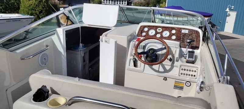 Slide: The Image of 1997 Crownline 250 CR boat interior with steering wheel and control panel. - 26