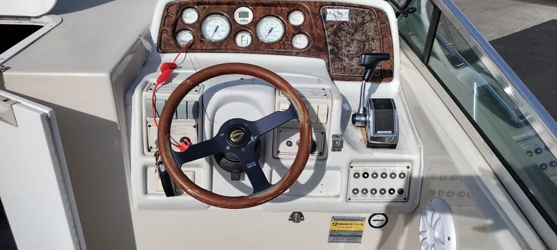 Slide: The Image of 1997 Crownline 250 CR boat dashboard with steering wheel and control panel. - 27