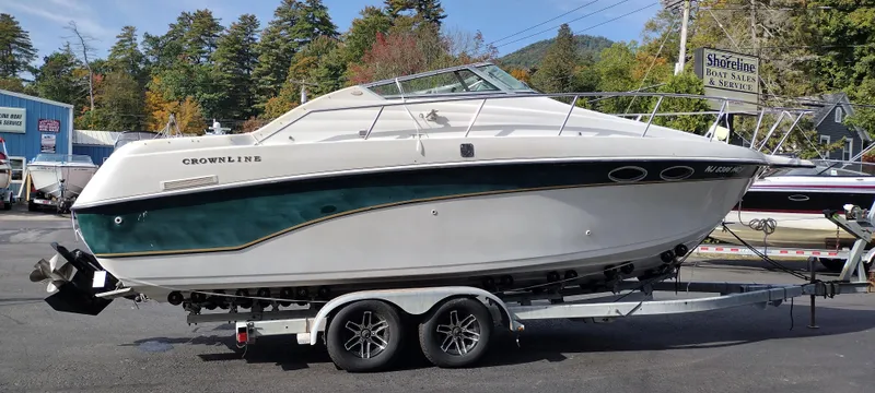 Slide: The Image of 1997 Crownline 250 CR boat on a trailer in a marina. - 4