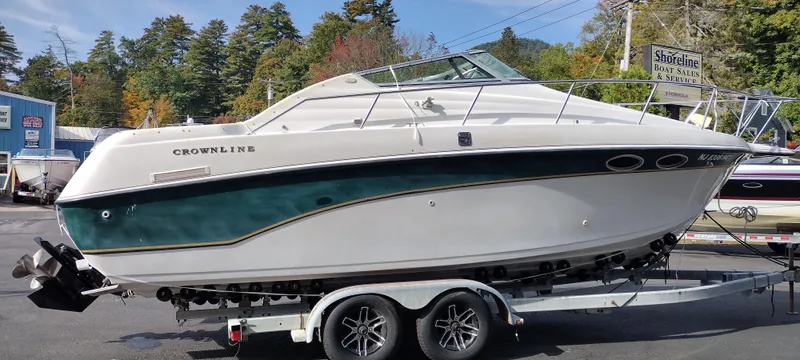 Slide: The Image of 1997 Crownline 250 CR boat on a trailer in a marina. - 5