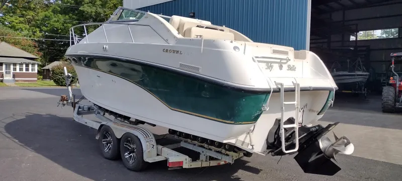 Slide: The Image of 1997 Crownline 250 CR boat on a trailer in a marina. - 8