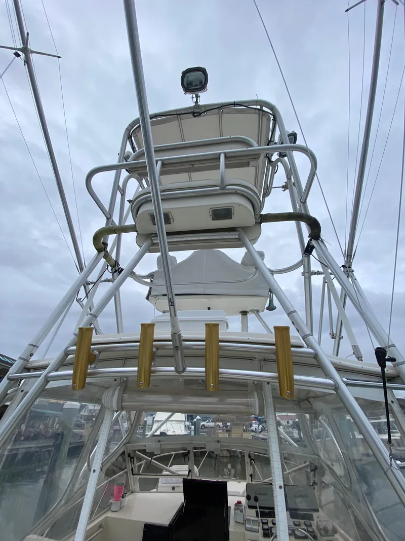 Slide: The Image of 2004 Carolina Classic 28 boat tower with rod holders and helm station. - 11