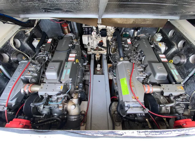 Slide: The Image of Engine compartment of a 2004 Carolina Classic 28 boat, featuring dual Yanmar engines. - 12