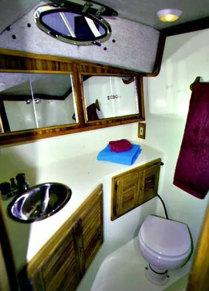Slide: The Image of Bathroom interior of 2004 Carolina Classic 28 boat with sink and toilet. - 7