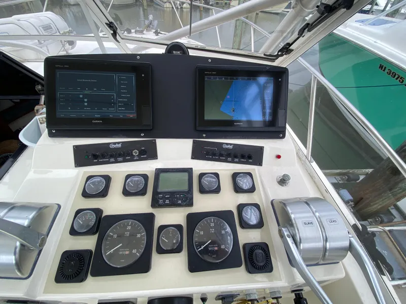 Slide: The Image of Control panel of a 2004 Carolina Classic 28 boat with navigation screens and gauges. - 8