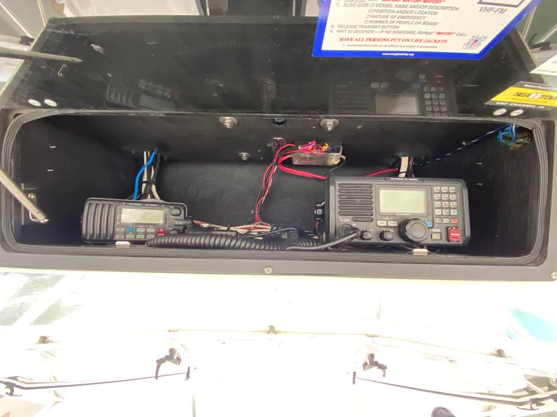 Slide: The Image of 2004 Carolina Classic 28 boat radio equipment in storage compartment. - 9