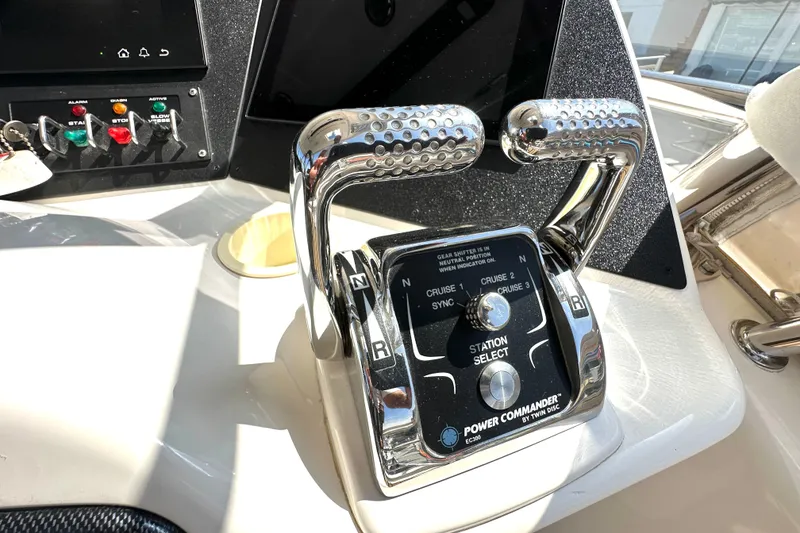 Slide: The Image of Control panel of a 2005 Riviera 47 Open Flybridge yacht with throttle levers. - 17