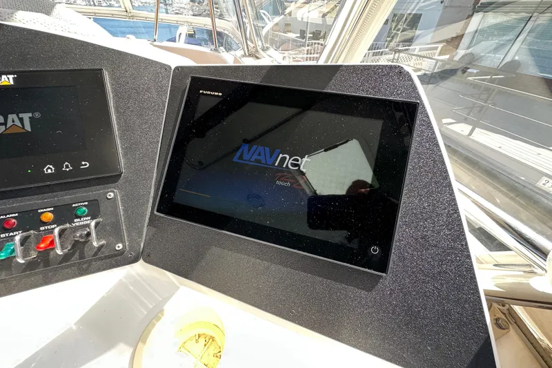 Slide: The Image of Control panel of 2005 Riviera 47 Open Flybridge with NAVnet display and CAT system. - 22