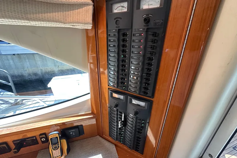 Slide: The Image of Control panel inside a 2005 Riviera 47 Open Flybridge yacht, featuring switches and meters. - 30