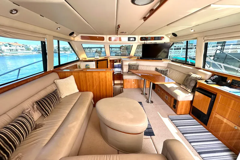 Slide: The Image of Luxurious interior of 2005 Riviera 47 Open Flybridge yacht with plush seating and elegant wood finishes. - 31