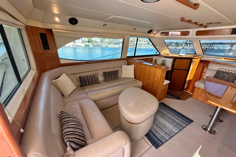 Slide: The Image of Luxurious interior of 2005 Riviera 47 Open Flybridge yacht with plush seating and scenic windows. - 32
