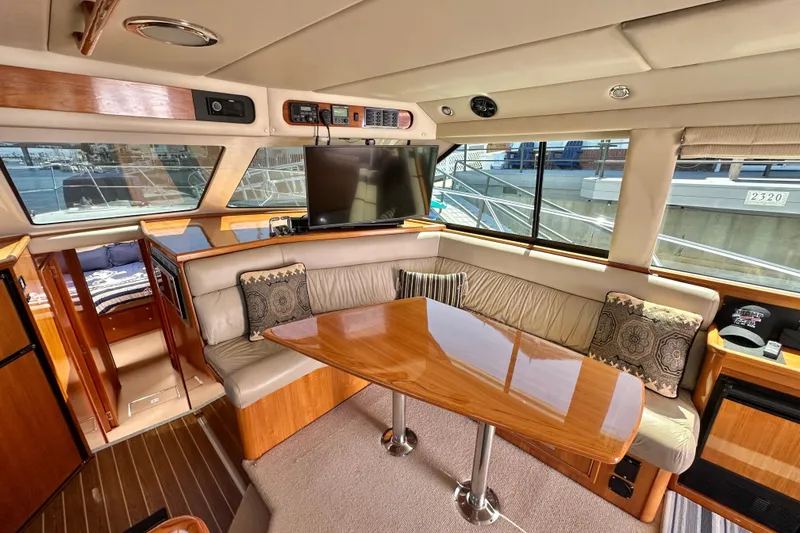 Slide: The Image of Luxurious interior of 2005 Riviera 47 Open Flybridge yacht with plush seating and wooden accents. - 33