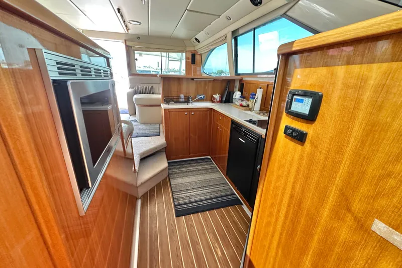 Slide: The Image of Luxurious 2005 Riviera 47 Open Flybridge yacht interior with modern kitchen amenities. - 37