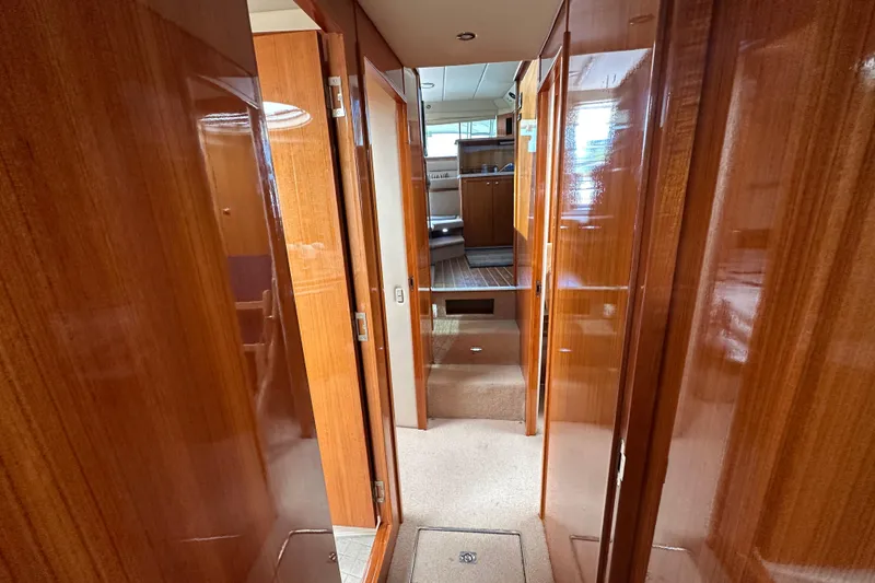 Slide: The Image of Interior hallway of 2005 Riviera 47 Open Flybridge yacht with polished wood finish. - 38