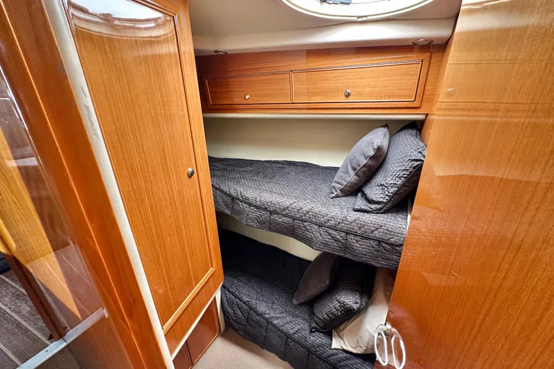 Slide: The Image of Interior of 2005 Riviera 47 Open Flybridge with wooden cabinetry and bunk beds. - 40