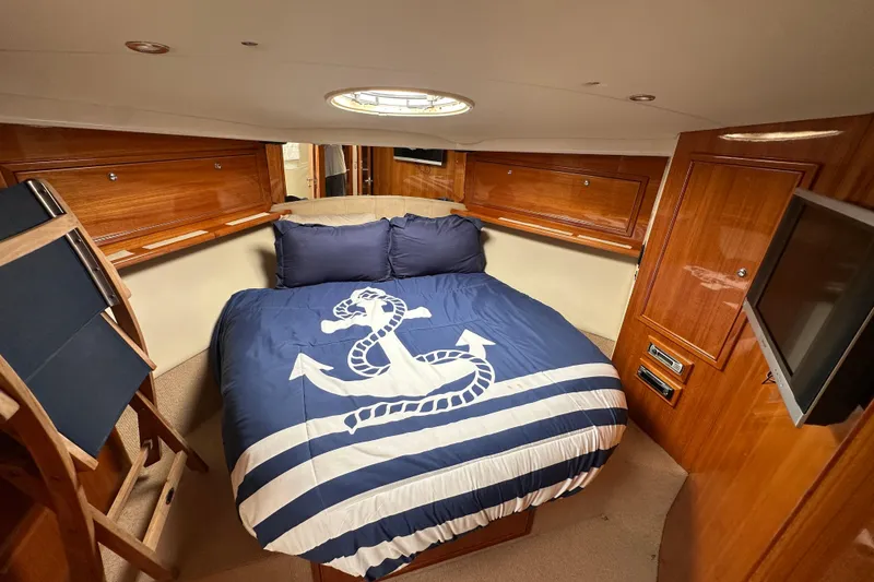 Slide: The Image of Luxurious cabin interior of 2005 Riviera 47 Open Flybridge yacht with nautical-themed bedding. - 45