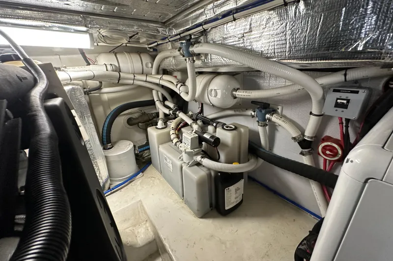 Slide: The Image of Engine room of 2005 Riviera 47 Open Flybridge with complex piping and equipment. - 46