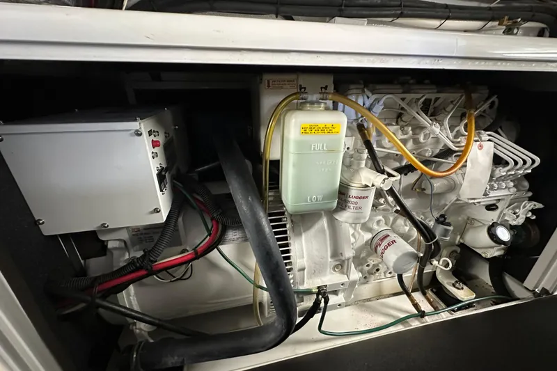 Slide: The Image of Engine compartment of a 2005 Riviera 47 Open Flybridge, showcasing mechanical components. - 47