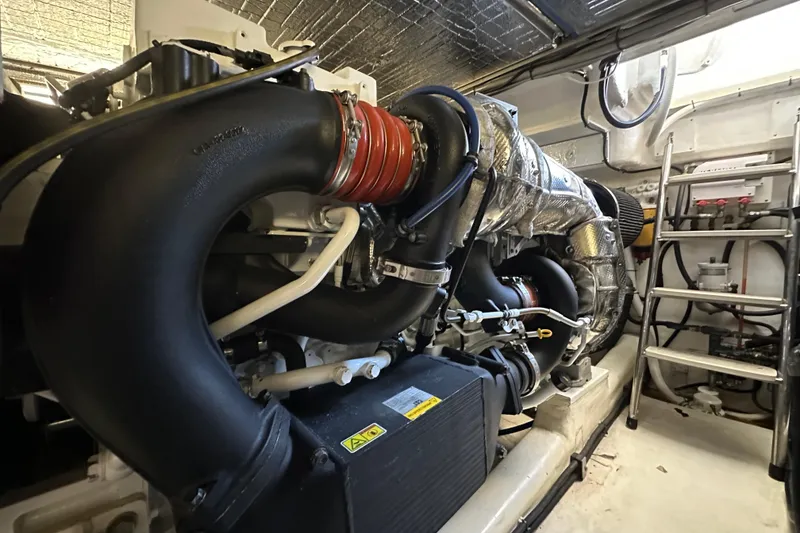 Slide: The Image of Engine room of 2005 Riviera 47 Open Flybridge yacht, showcasing detailed machinery and components. - 49