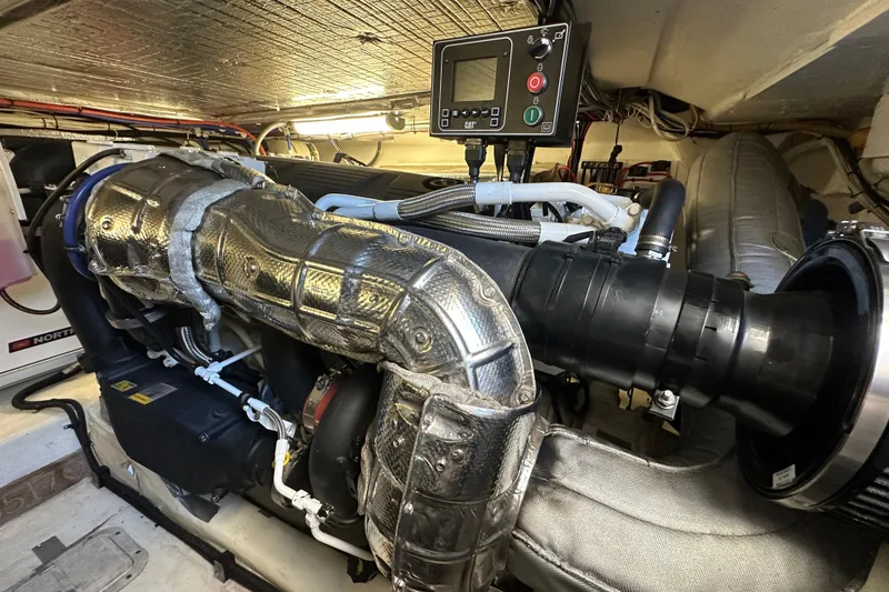 Slide: The Image of Engine room of 2005 Riviera 47 Open Flybridge with visible machinery and control panel. - 50