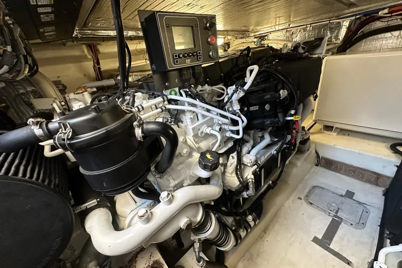 Slide: The Image of Engine room of a 2005 Riviera 47 Open Flybridge yacht, showcasing detailed machinery. - 52