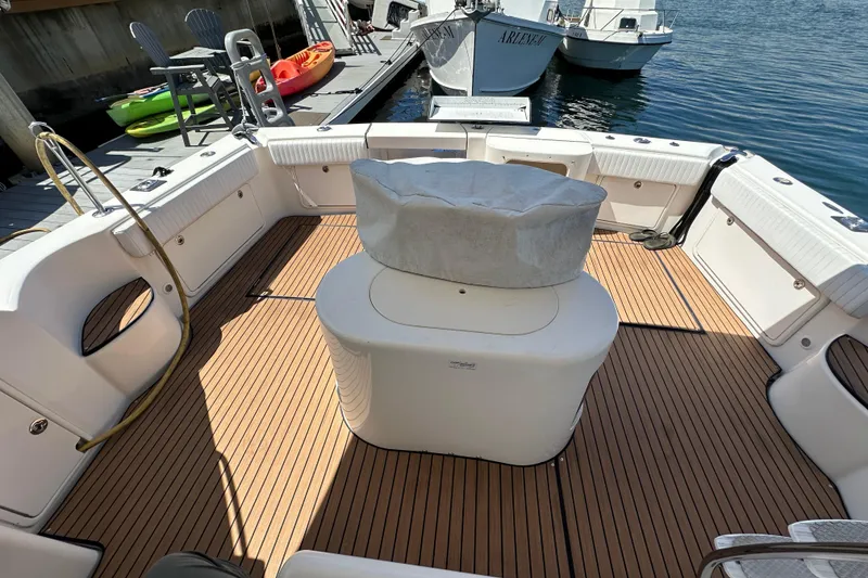 Slide: The Image of Spacious deck of 2005 Riviera 47 Open Flybridge yacht, docked with kayaks nearby. - 53