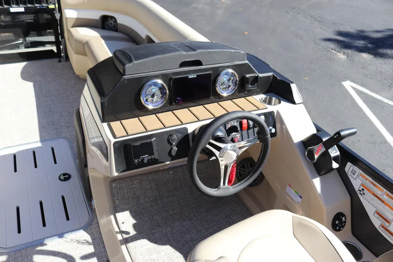 Slide: The Image of 2024 Premier 250 SunSation RF boat dashboard with steering wheel and controls. - 13