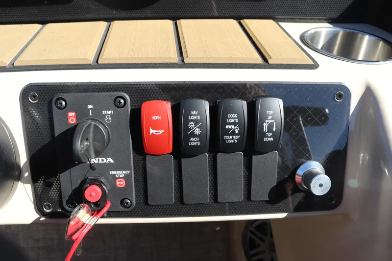 Slide: The Image of Control panel of 2024 Premier 250 SunSation RF boat with switches and ignition. - 16