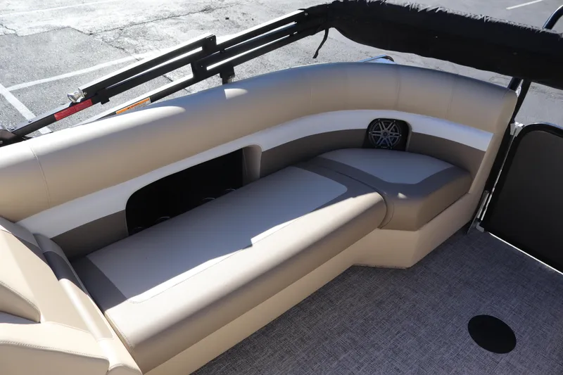 Slide: The Image of 2024 Premier 250 SunSation RF boat interior with beige seating and speaker. - 18