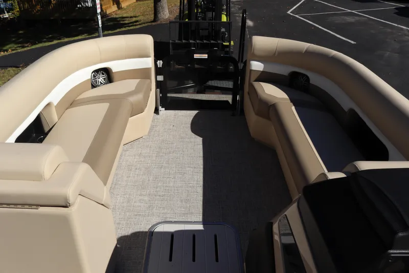 Slide: The Image of 2024 Premier 250 SunSation RF pontoon boat interior with beige seating and carpet. - 6