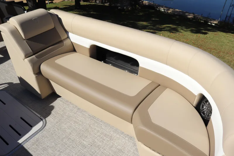 Slide: The Image of 2024 Premier 250 SunSation RF boat interior with beige seating and storage compartment. - 8
