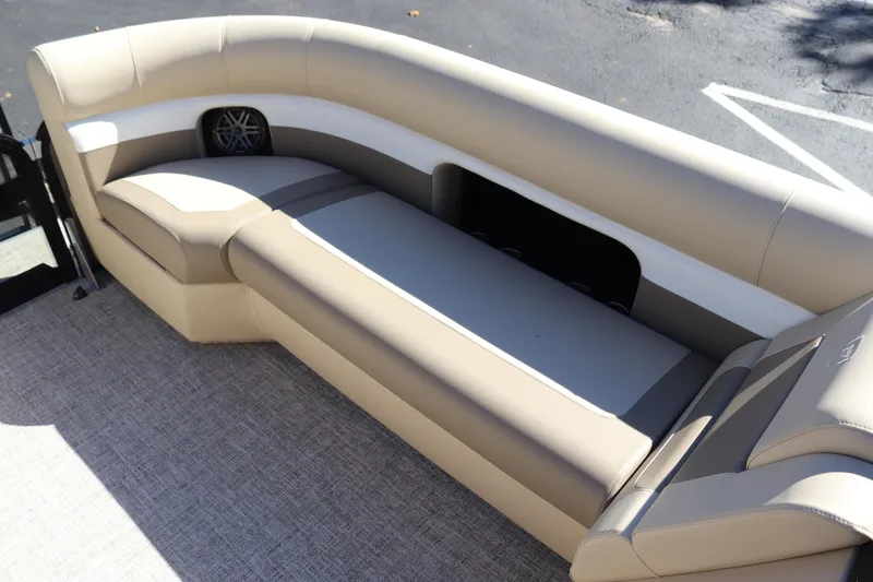 Slide: The Image of 2024 Premier 250 SunSation RF boat interior with beige seating and speaker. - 9